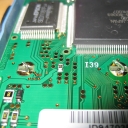 The PCB held down by metal tabs